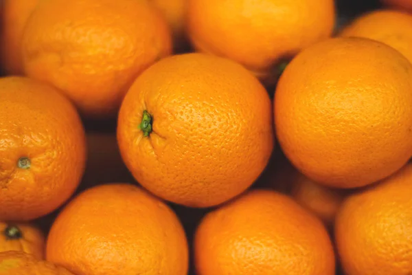 Fresh oranges texture. Bunch of fresh  oranges on market, Stack of oranges. Pile of a Fresh Oranges for Background. Orange fruit background