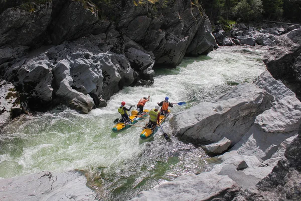 Extreme rafting on the Bashkaus River, extreme sportsmen go thran, Russia, the Altai Republic.  Clean air of Altai and the beauty of Siberiaough the difficult turbine rapid on a catamar