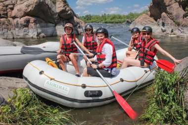 Mygiya / Ukraine - July 22 2018: Women's team on the rafting. Rafting at Southern Bug river with White Water Rafting adventure in Ukraine clipart