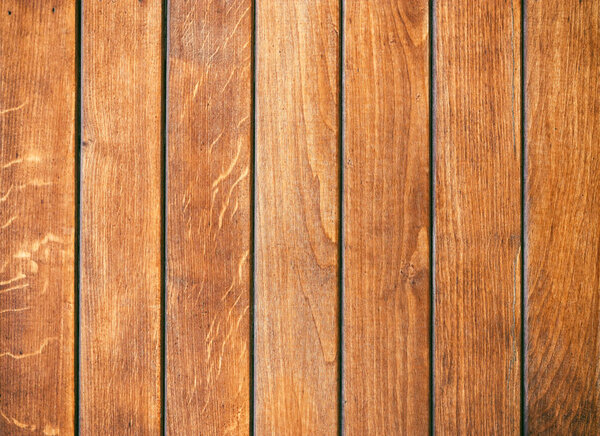 Old wooden background with vertical brown boards. Wooden background, painted surface brown boards.  Weathered brown wood background texture.