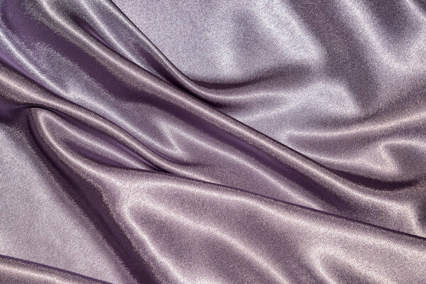 Beautiful smooth elegant wavy violet purple satin silk luxury cloth texture, abstract background design. Карточка или баннер. Швейная абстракция материала

