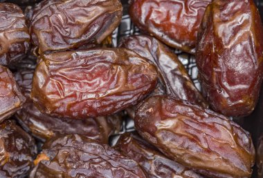 Date palm on a traditional craftsman market.Horizontal image. Dried fruits dates macro.