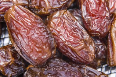 Date palm on a traditional craftsman market.Horizontal image. Dried fruits dates macro.