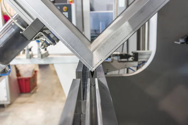 Metal levhaları kağıt bükme makineleriyle büken operatör.
