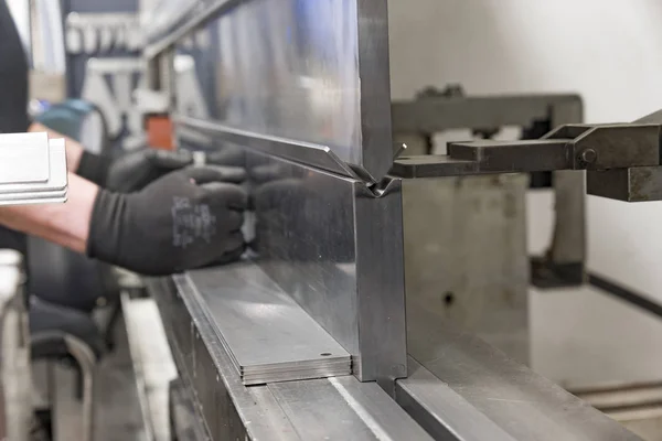 operator bending metal sheet by sheet bending machine