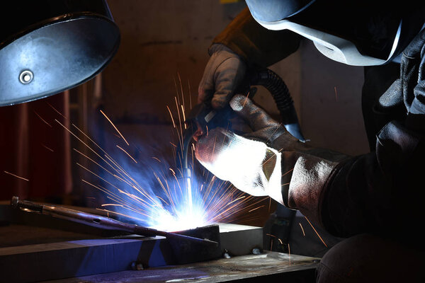 Industrial steel welder in factory welder, craftsman