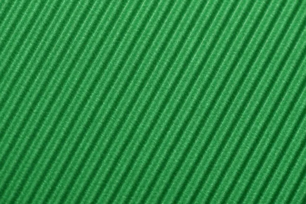 Light green colored corrugated cardboard texture useful as a background Textured corrugated striped cardboard green
