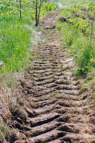 a tractor track, the trace of the tractor on the ground, even the tread in the ground