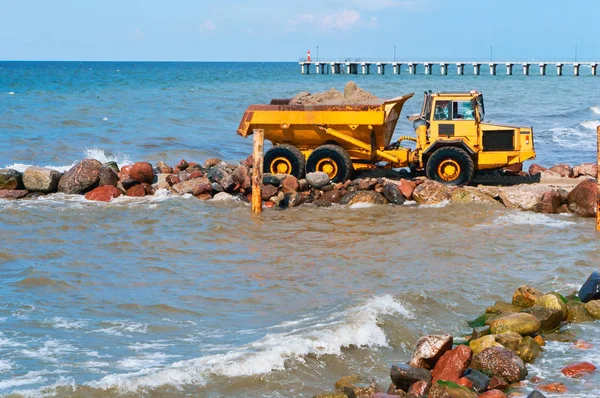 construction equipment on the shore, the construction of breakwaters, coastal protection measures