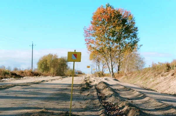 mark road repairs, the elevation of the curb of a dirt road