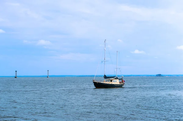 8 September 2018, Kaliningrad region, Russia, black and white yacht on the water, yacht with lowered sails