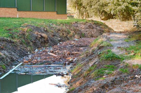 dirty stream, garbage and waste in the river