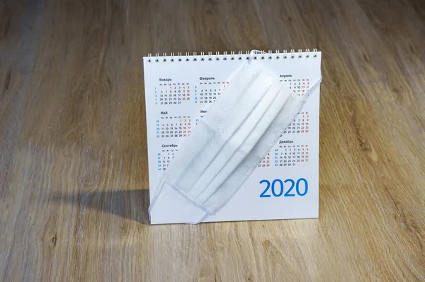 medical white mask and calendar for 2020, medical face mask on the table