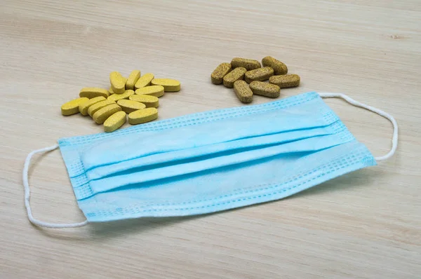 medicines and disposable medical mask, medical mask and yellow tablets