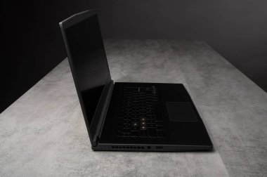 Stüdyo ortamında siyah ekranı olan modern siyah bir dizüstü bilgisayar. İş, eğitim, yazılım, teknoloji ve çevrimiçi iş kavramları için uygundur.