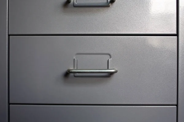 Filing cabinet with closed drawer, Grey silver metal colour, Administration and storage concept, closeup & Macro shot