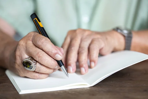 Carta de escritura a mano para hombre mayor sobre papel de color marfil, Cuaderno, Una pluma de plata de mezcla negra, Sobre fondo de madera, Primer plano y plano macro, Enfoque selectivo, Concepto de papelería — Foto de Stock