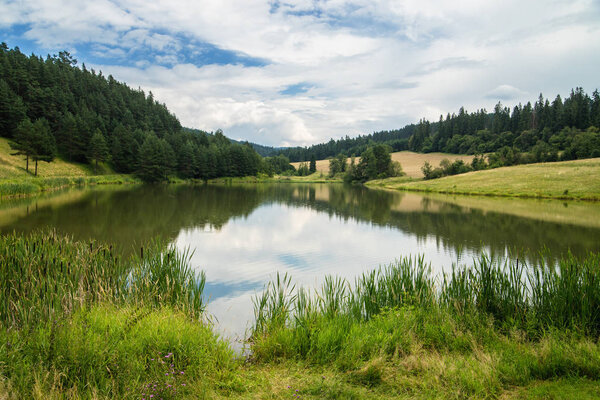 Lake called Zlatna surrounded with meadows and forest, Levocske vrchy mountains, Slovakia.