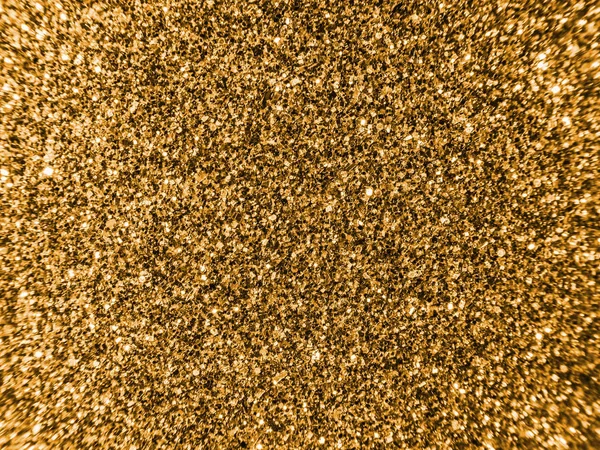 Background sequin. Golden glitter sparkle. glitter surfactant. Holiday abstract glitter background with blinking lights. Fabric sequins in bright colors. Fashion fabric glitter, sequins.