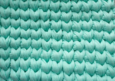 Closeup pamuk turkuaz örgü battaniye, sıcak ve rahat bir atmosfer. Örgü arka plan