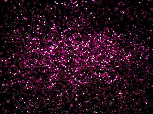 Pink glitter sparkle on black background with place for your text