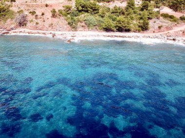 Kızıl kayalıkların ve Sveti Stefan Montenegro 'daki güzel parlak renklere sahip denizin insansız hava aracı fotoğrafı