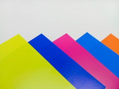 Parlak neon renklerde üstüste binen köşegenlerin parlak, mavi, morumsu ve turuncu bileşimi, temiz beyaz bir arkaplana karşı..