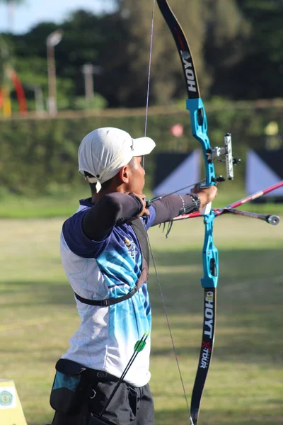 Banda Aceh, Indonesia - September 10, 2025: Focused archer aiming with a professional recurve bow during outdoor archery practice