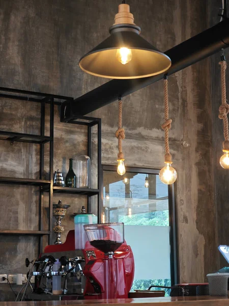 Industrial style coffee shop interior featuring a bright red espresso machine