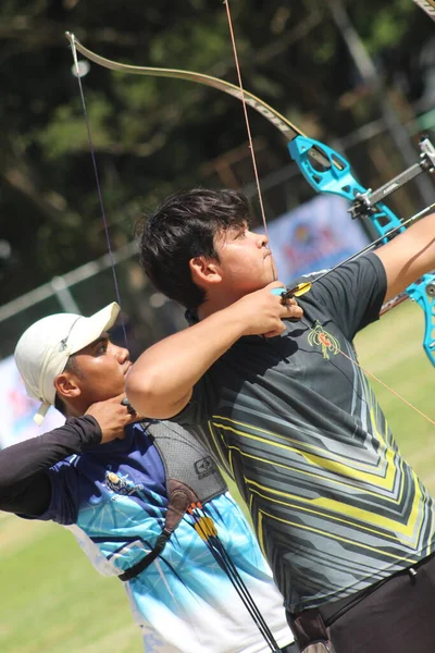 Banda Aceh, Indonesia - September 20, 2025: The athletes are focused and ready to release their arrows, showcasing precision, concentration, and competitive spirit