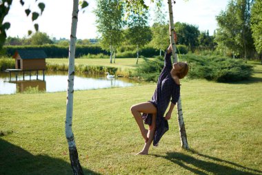 A woman in a dress from a tree