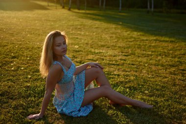 A woman sitting on grass