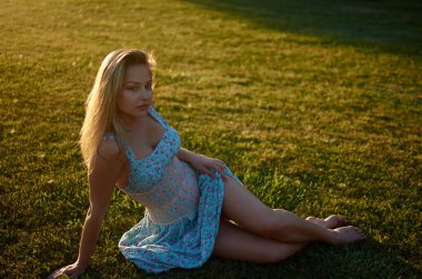 A woman sitting on grass