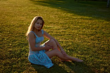 A woman sitting on grass