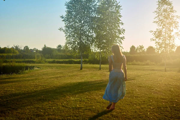 A woman walking on grass