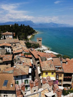 High view over Sirmiones medieval rooftops and the harbor projecting into Lake Garda.