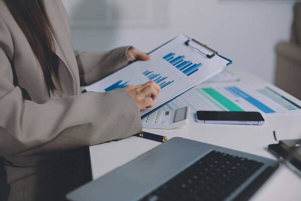 Portrait of young Hispanic professional business woman standing in office. Happy female company executive, smiling businesswoman entrepreneur corporate leader manager looking at camera using tablet