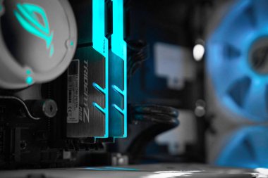 Cutting-edge computer components are showcased with vibrant LED lights illuminating the motherboard. The sleek design and efficient cooling enhance performance and aesthetics.