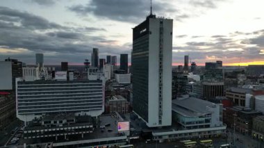 As the sun sets, the skyline of a vibrant city comes alive with stunning modern buildings and an array of bustling activities, showcasing urban energy and beauty.