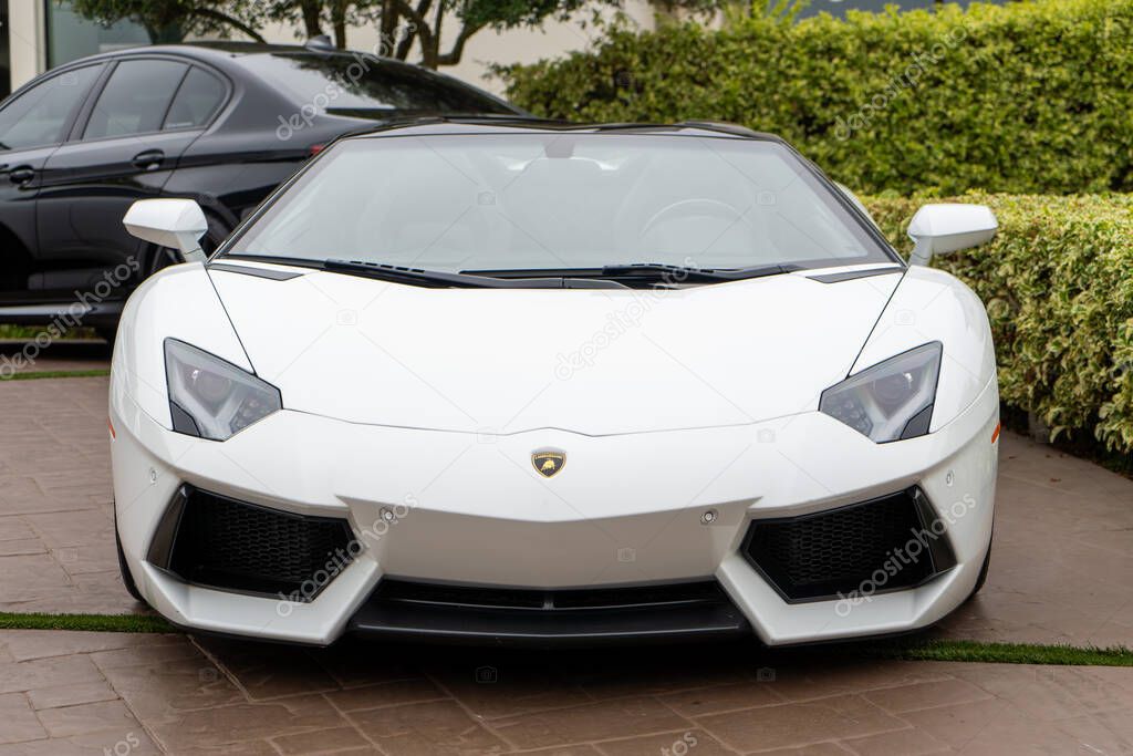 Front view of a white Lamborghini Aventador parked outdoors. Luxury sports car, sleek design.