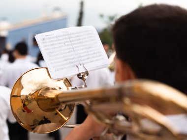 Musician playing the trombone viewed from behind