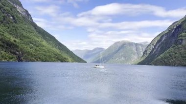 Yacht in the Norwegian fjords among the mountains