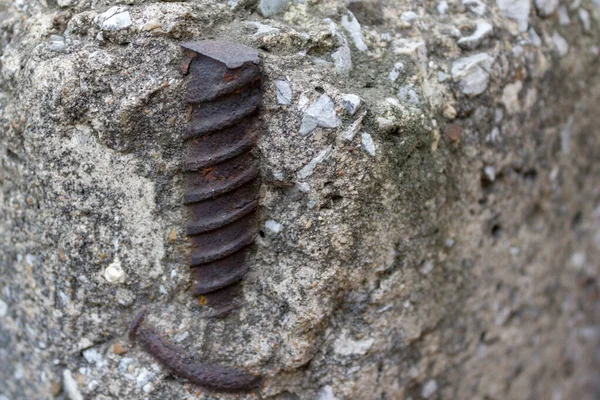 Metal fittings are embedded in the concrete wall.