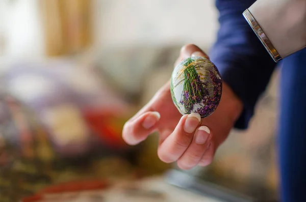 Easter egg with the technique of decoupage. Woman creation work on colored Easter egg, with the technique of decoupage