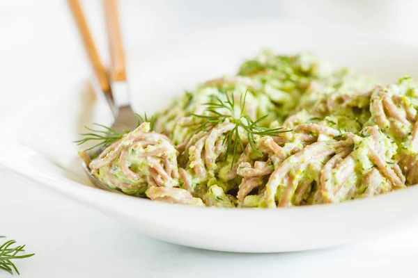 Vegetarian Soba Noodles with green broccoli sauce (pesto). Healthy vegan food concept.