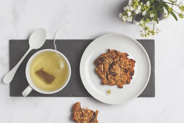 Green (herbal, white) tea with cookies on white background. Flat lay food, breakfast lifeslyle concept