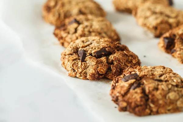 Vegan oatmeal cookies with chocolate on a light background. Food blog style concept.