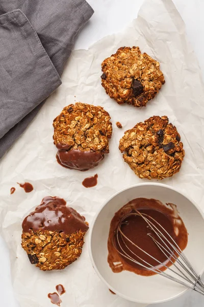 Vegan oatmeal cookies with chocolate on a light background. Food blog style concept.