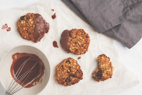 Vegan oatmeal cookies with chocolate on a light background. Food blog style concept.