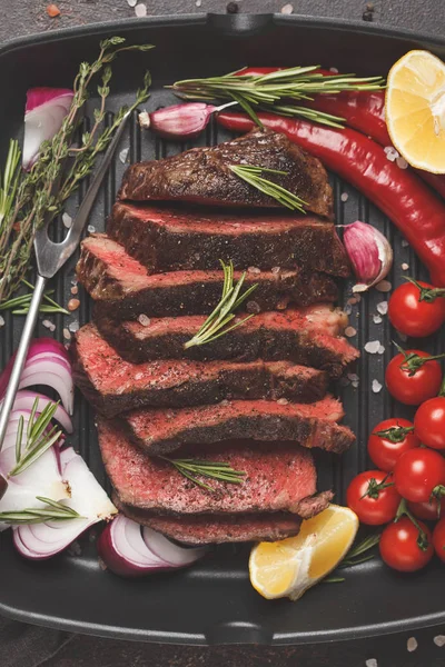 Baharatlar ve sebzeler, üstten görünüm, makro ile bir tavada ızgara biftek dilimlenmiş